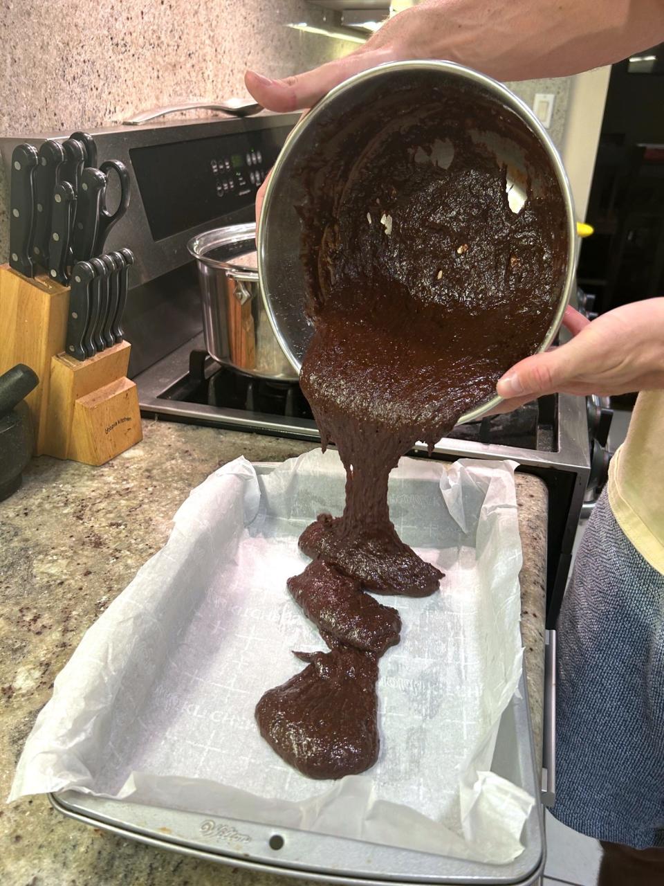 Adding batter to pan for Gordon Ramsay's Brownies