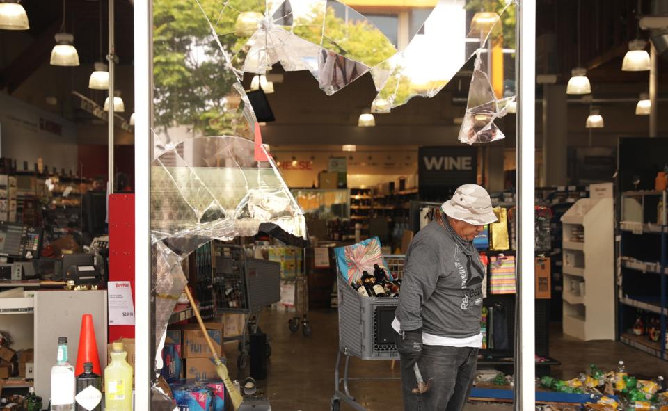 A workers cleans up at a BevMo on La Cienega Boulevard.