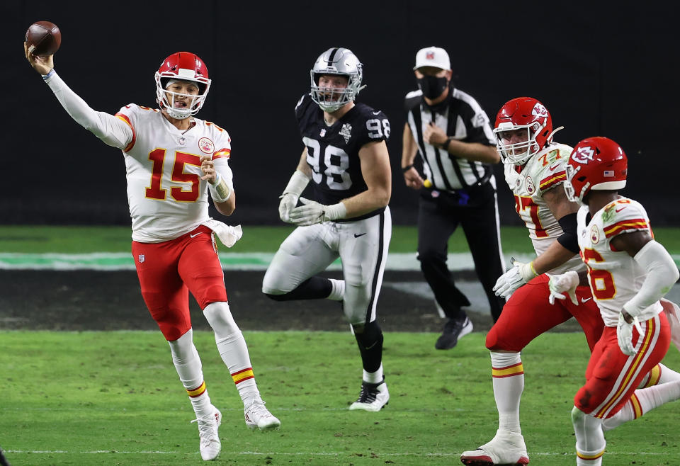 LAS VEGAS, NEVADA - NOVEMBER 22:  Quarterback Patrick Mahomes #15 of the Kansas City Chiefs throws a pass pressured by defensive end Maxx Crosby #98 of the Las Vegas Raiders during the NFL game at Allegiant Stadium on November 22, 2020 in Las Vegas, Nevada. The Chiefs defeated the Raiders 35-31.  (Photo by Christian Petersen/Getty Images)