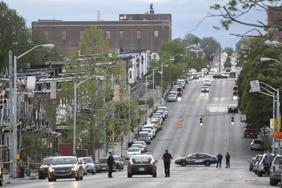 Police work near the scene where authorities say several people were shot, at least one fatally, Sunday, April 28, 2019, in Baltimore. (AP Photo/Steve Ruark)