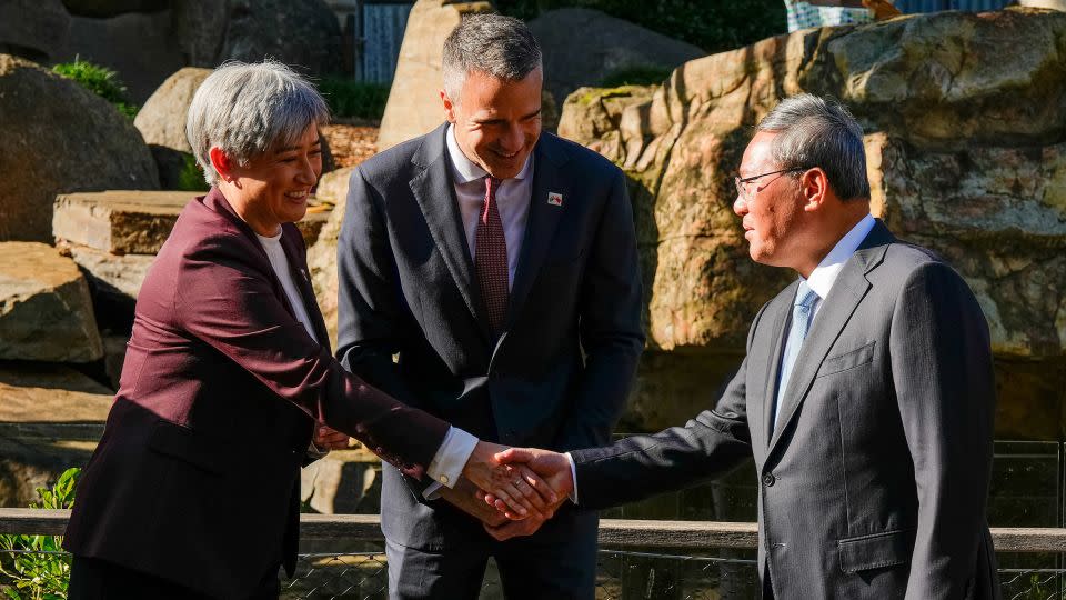 Australia's Foreign Minister Penny Wong (left) shakes hands with China's Premier Li Qiang as South Australian Premier Peter Malinauskas looks on at Adelaide Zoo on June 16, 2024. - Asanka Ratnayake/Pool/Reuters