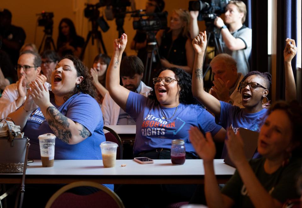 Jul 5, 2023; Columbus, OH, USA;  (from L) Lena Collins, Manager of Social Impact at Ohio Women's Alliance, Jordyn Close, Deputy Director with Ohio Women's Alliance  and Maggie Scotece, Interim Executive Director of the Abortion Fund of Ohio cheer as Kellie Copeland, Executive Director of Pro-Choice Ohio, speaks at a press conference after signatures for the reproductive freedom ballot initiative were dropped off at the loading dock of the office of the Secretary of State office in Downtown Columbus.