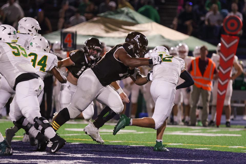 Wisconsin football recruit Dillan Johnson, a defensive lineman from Joliet Catholic Academy near Chicago, tackles a ball carrier during the 2023 season.