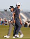 South Africa's Louis Oosthuizen, rear walks on the 17th green as tUnited States' Collin Morikawa, passes during the third round of the British Open Golf Championship at Royal St George's golf course Sandwich, England, Saturday, July 17, 2021. (AP Photo/Peter Morrison)