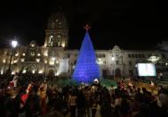 People gather at San Francisco Square in front of a Christmas tree, in La Paz December 24, 2013. REUTERS/David Mercado (BOLIVIA - Tags: SOCIETY)