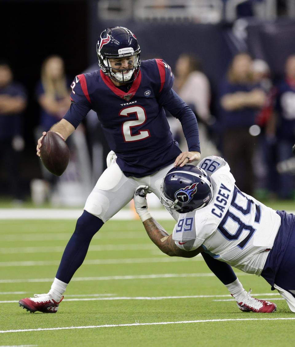 Houston Texans quarterback AJ McCarron (2) is sacked by Tennessee Titans defensive end Jurrell Casey (99) during the first half of an NFL football game Sunday, Dec. 29, 2019, in Houston. (AP Photo/Michael Wyke)