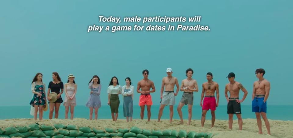 The singles father around a mud pool and the announcer says the male participants will play a game for dates in Paradise