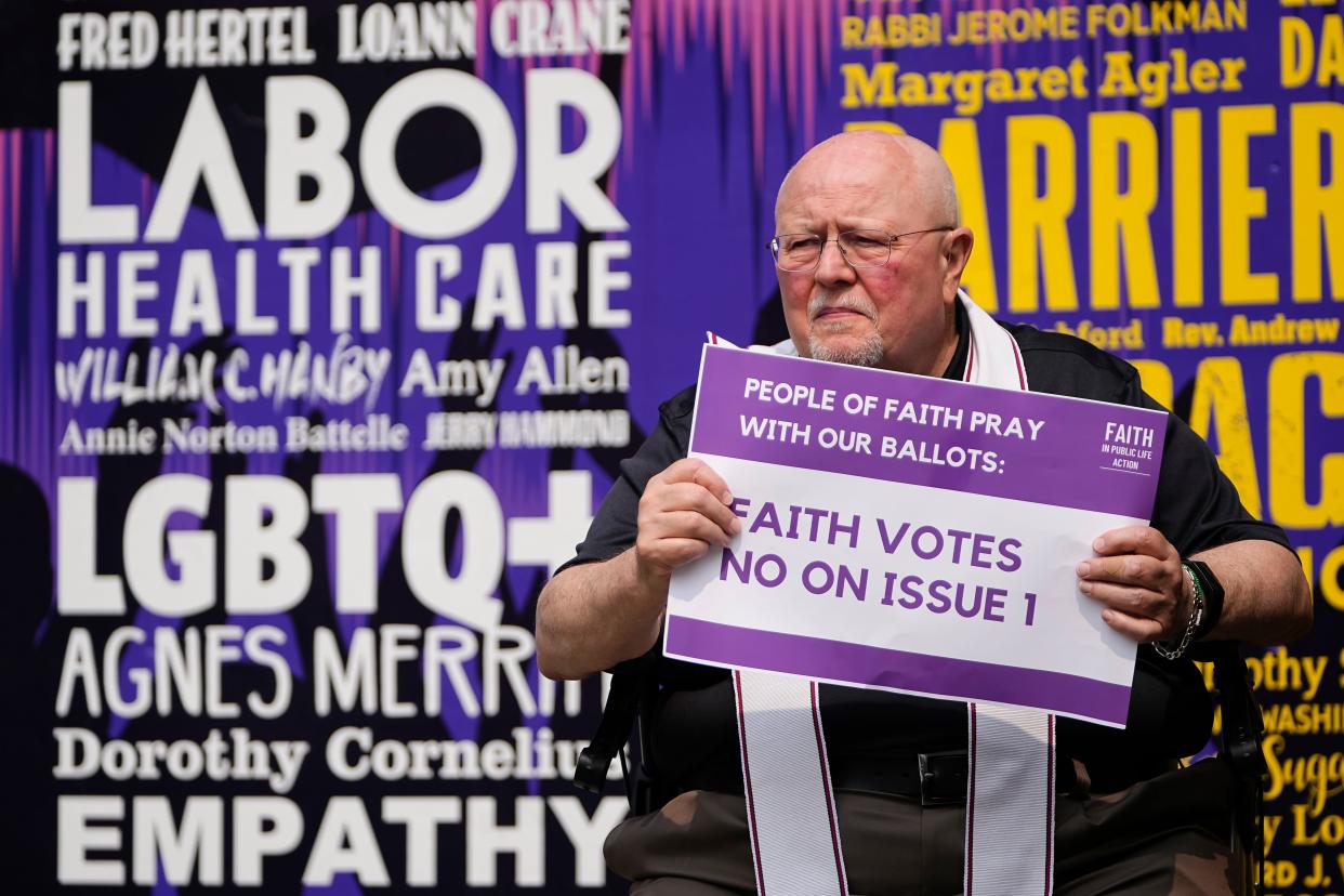 The Rev. Jim Wilson of Prince of Peace Lutheran Church holds a “Faith Votes No on Issue 1” sign during a gathering of Columbus faith leaders speaking out against Issue 1 in a “Faith Votes No” rally at Washington Gladden Social Justice Park Downtown.