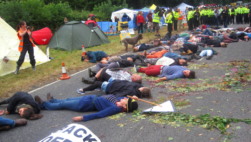 Anti-fracking activists pretending to drop down dead in the middle of the road after a lorry had delivered equipment to a proposed oil exploration drilling site outside Balcombe, West Sussex.