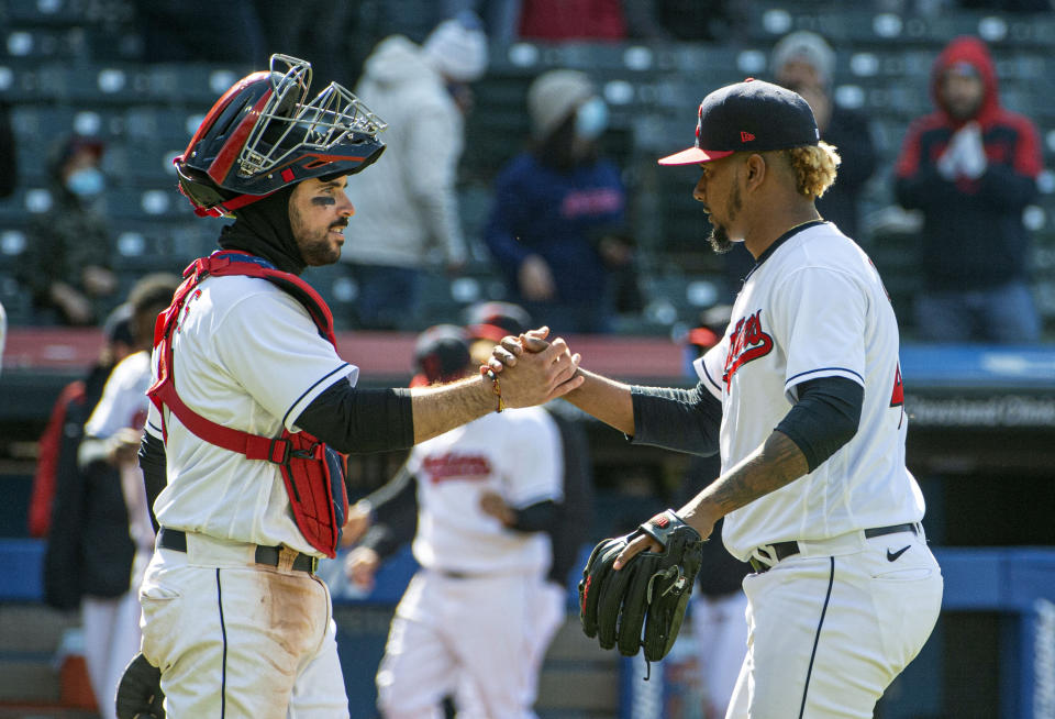 Cleveland Indians' catcher Austin Hedges congratulates closer Emmanuel Clase after the final out against the New York Yankees at a baseball game in Cleveland, Sunday, April 25, 2021. (AP Photo/Phil Long)