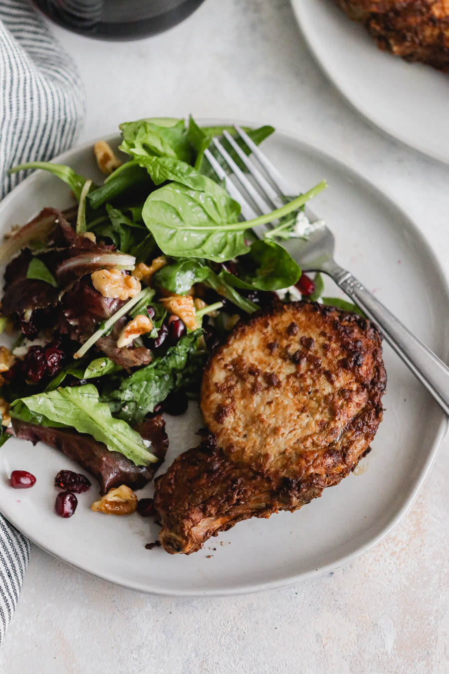 An air fried pork chop with salad.