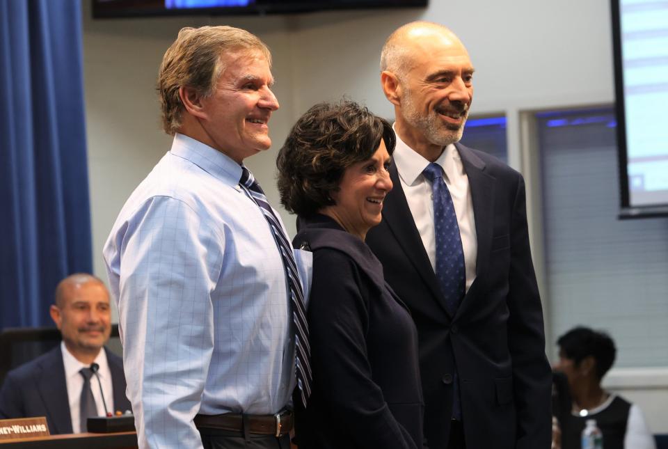 From left, assistant superintendent Alan Cox, school board member Laurie Cox and former Florida Supreme Court Justice Alan Lawson pose for a photo at a Leon County School Board meeting on Tuesday, Nov. 22, 2022.