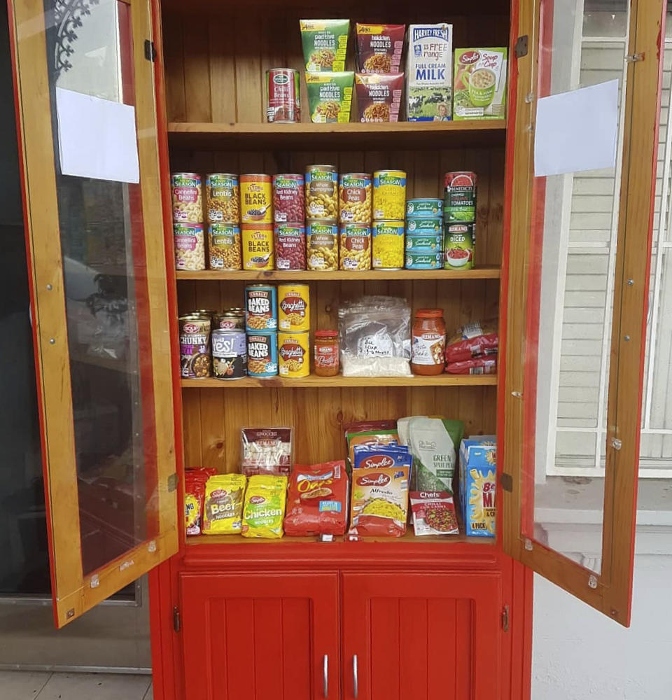 In this July 19, 2020 photo provided by Rick Everett, a free food pantry sits outside his home in Sydney, Australia, where he offers coffee, home-cooked meals and conversation to friends and neighbors during the coronavirus pandemic. (Rick Everett via AP)