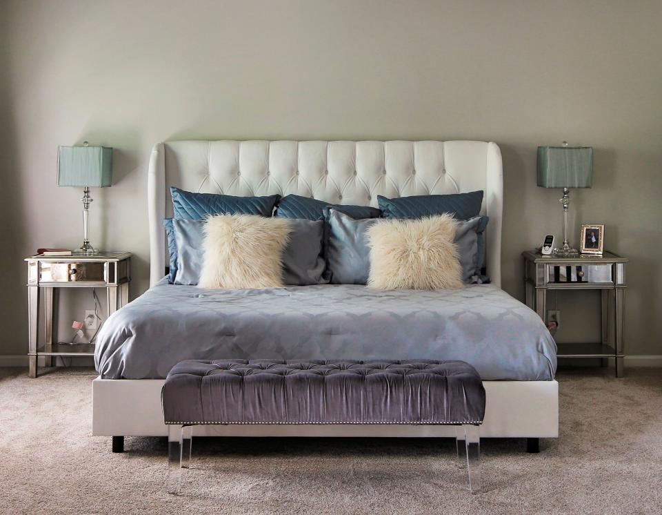 This undated photo provided by Interiors by Design shows a Lucite bench at the end of a bed which adds a whimsical touch while also providing a pop of color and texture without the visual weight of a normal piece of furniture. (Nick Schale/Interiors by Design via AP)