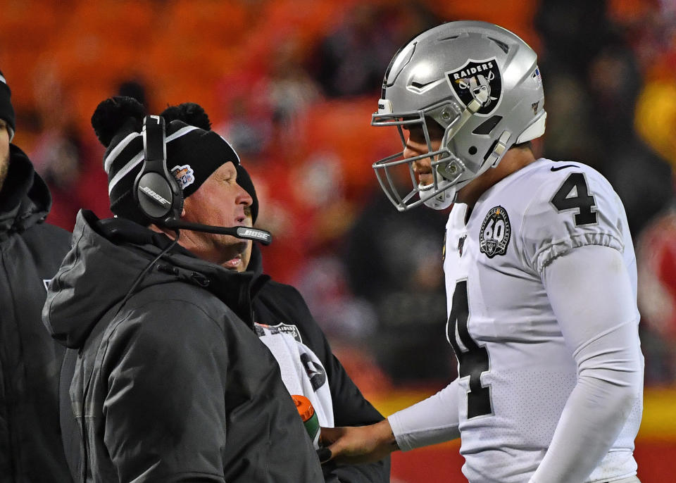 KANSAS CITY, MO - DECEMBER 01:  Head coach Jon Gruden of the Oakland Raiders talks with quarterback Derek Carr #4 during the second half against the Kansas City Chiefs at Arrowhead Stadium on December 1, 2019 in Kansas City, Missouri. (Photo by Peter Aiken/Getty Images)