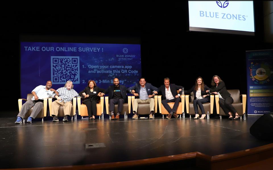 A panel of community stakeholders and Blue Zones staff link arms to commemorate the kickoff of the Blue Zones project in south Phoenix. A dozen community members will be a part of the initiative's steering committee.