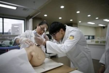 Nursing student Jang Dong-hae, 25, practices during a lecture at Bucheon University in Bucheon, South Korea, November 10, 2015. REUTERS/Kim Hong-Ji