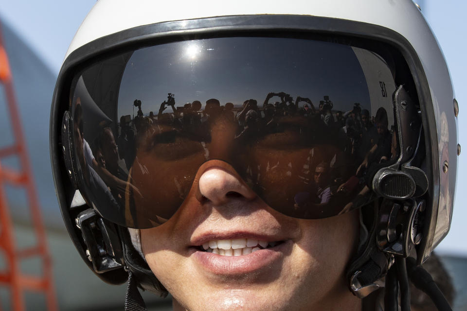 Russian air force pilot Ivan, no second name given, smiles as he speaks to foreign journalists at a Su-35 fighter jet at Hemeimeem air base in Syria, Thursday, Sept. 26, 2019. (AP Photo/Alexander Zemlianichenko)