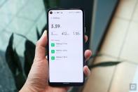 <p>OnePlus Watch review photos. A hand holding up a Pixel phone showing the OnePlus Health app's "Walking" page. Three sessions are logged under 2021, and the top of the page shows 3.39 miles total, 3 sessions clocked, 412 kcal burned and a longest session of 1.38 miles.</p> 