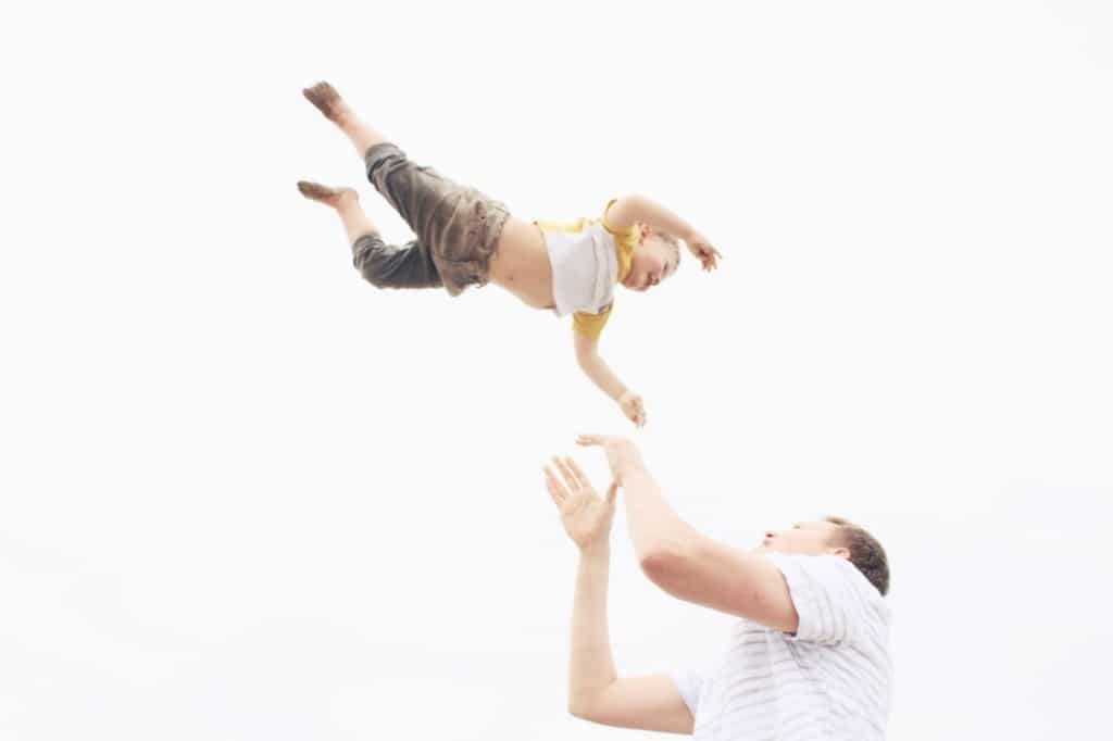 roughhousing: dad tossing child into the air