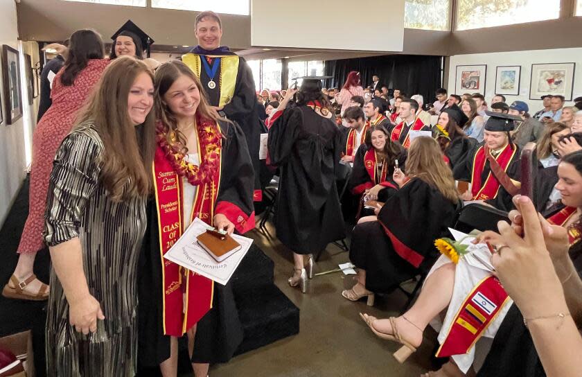 A graduate has her picture taken following the Chabad-Hillel Jewish graduation ceremony on May 10, 2024. (Matt Hamilton / Los Angeles Times)