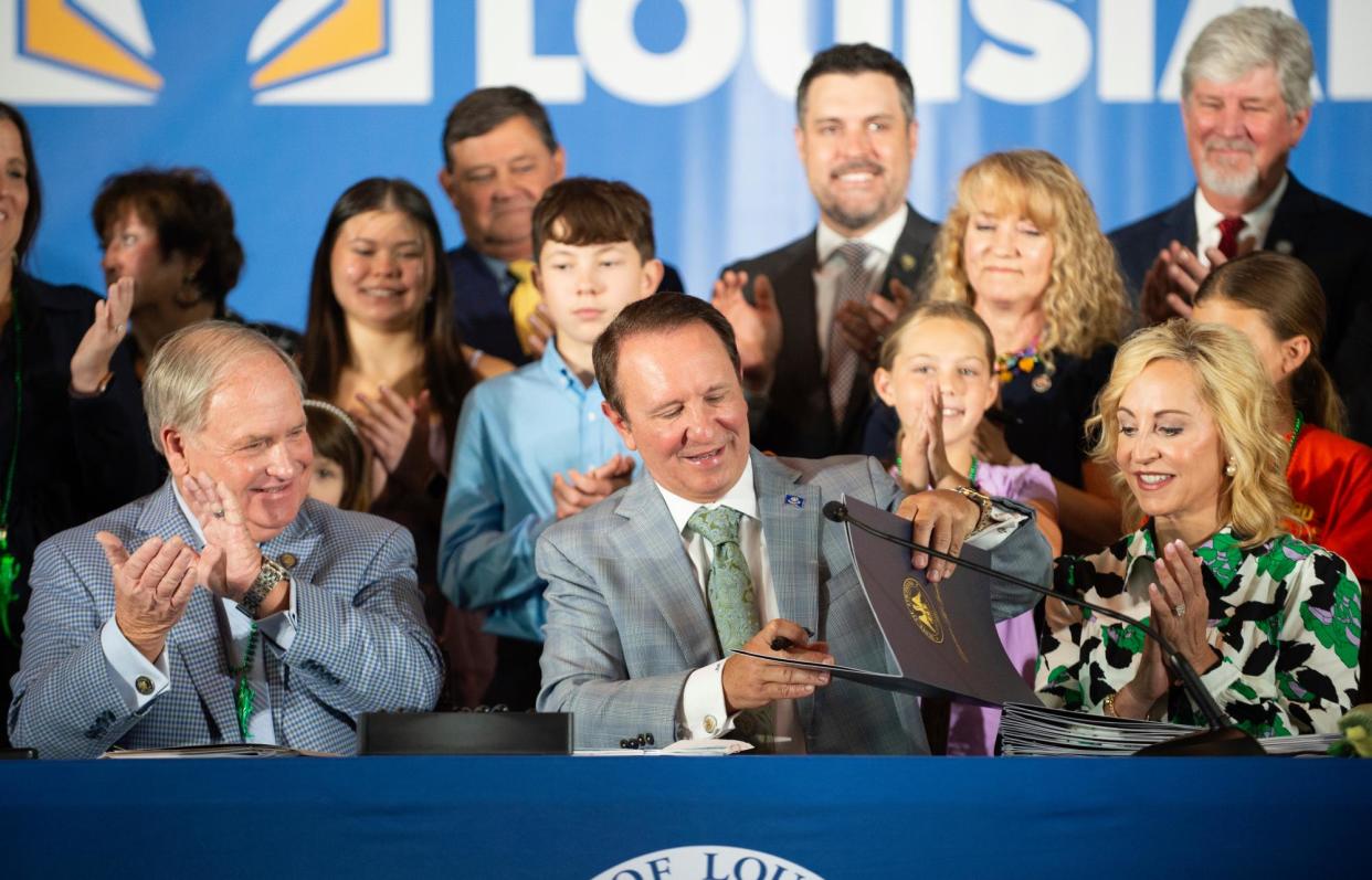 <span>Jeff Landry signs bills related to his education plan in Lafayette, Louisiana, on Wednesday.</span><span>Photograph: Brad Bowie/The Times Picayune/The New Orleans Advocate via AP</span>