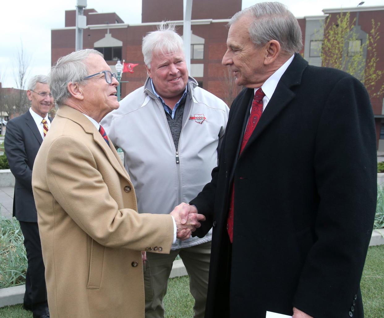 Gov. Mkle DeWine, left, shakes hands with Canton Mayor Thomas M. Bernabei after arriving at Centennial Plaza in Canton in April 2022.
