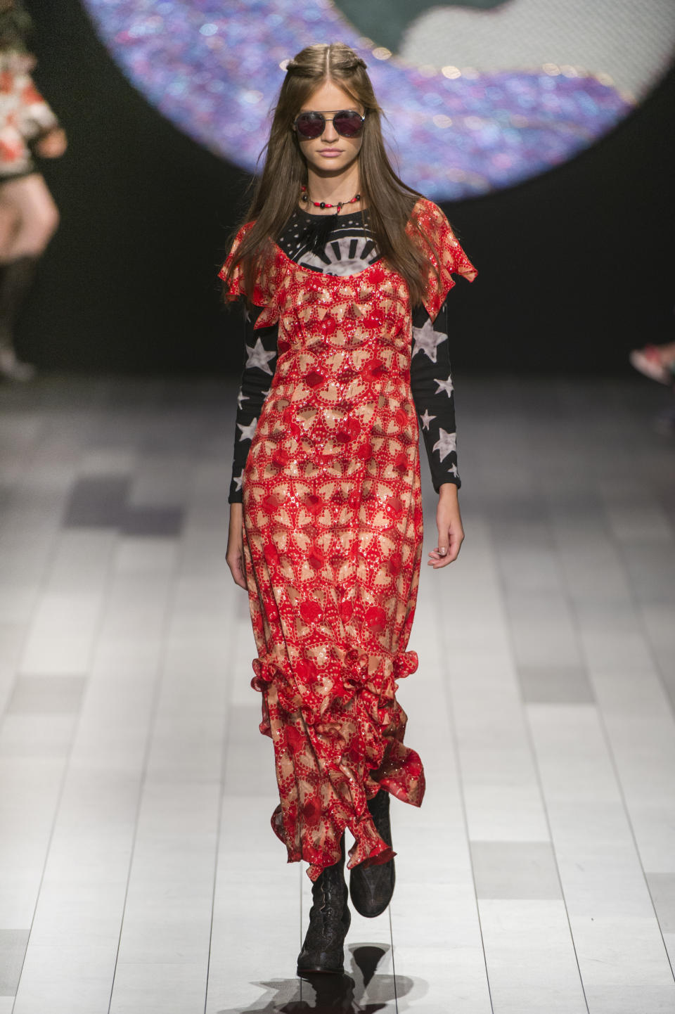 <p><i>Model wears a star-printed top under a sparkly red frilly dress from the SS18 Anna Sui collection. (Photo: ImaxTree) </i></p>