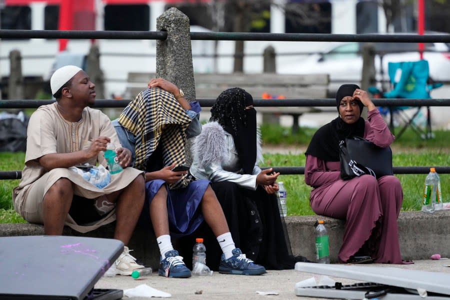 People gather in the aftermath of a shooting at an Eid al-Fitr event in Philadelphia, Wednesday, April 10, 2024. (AP Photo/Matt Rourke)