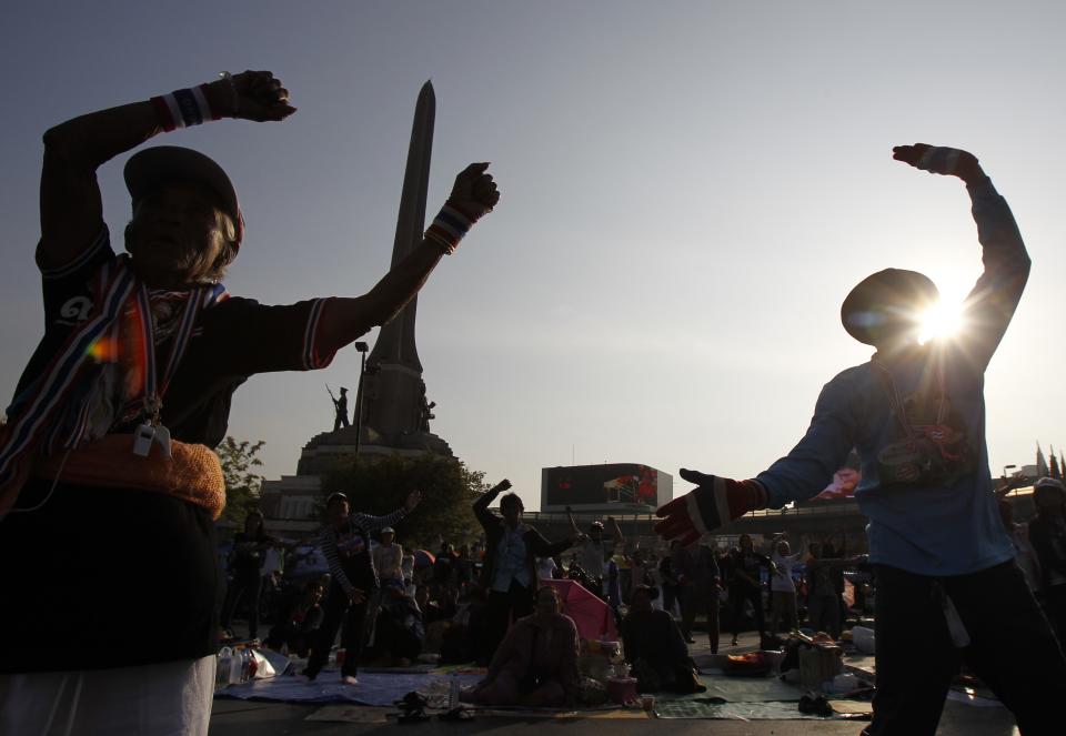 Anti-government protesters exercise as they take part in a rally at the Victory Monument in Bangkok
