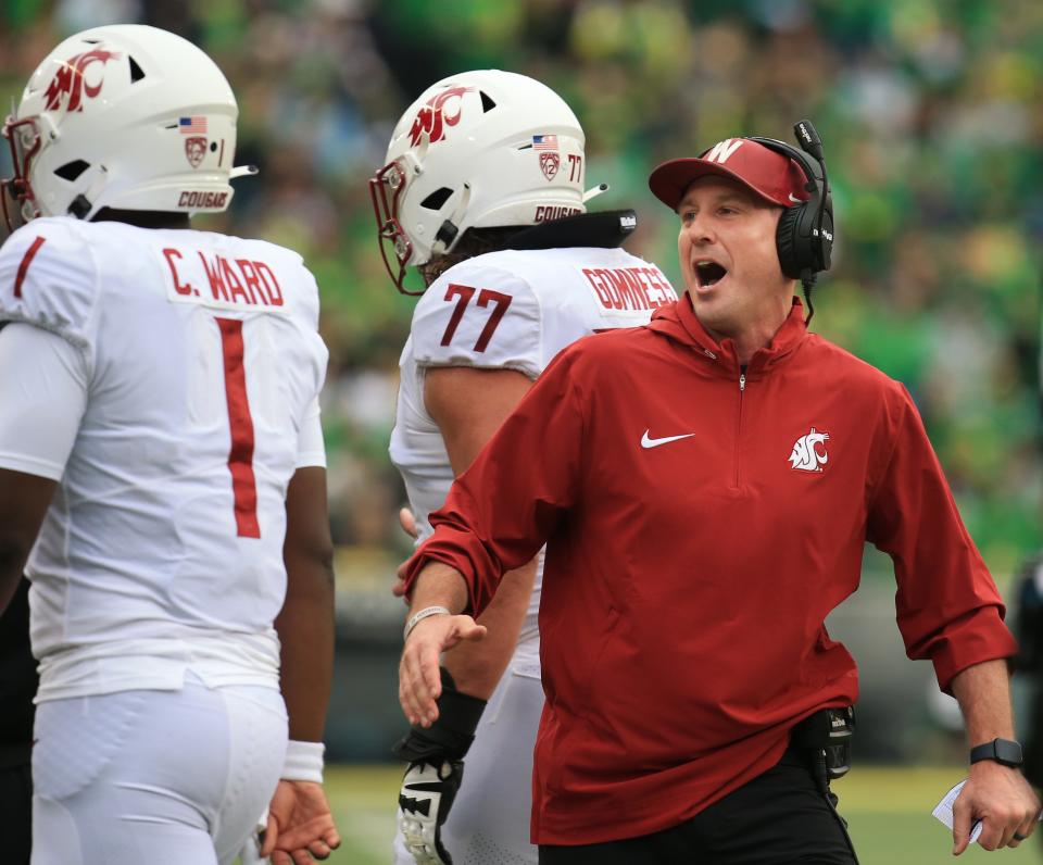 Washington State coach Jake Dickert celebrates with his team during the second quarter against Oregon at Autzen Stadium Saturday, Oct. 21, 2023.