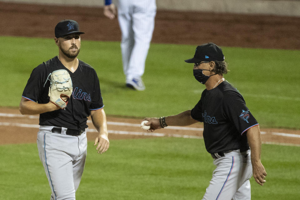 Miami Marlins pitcher Daniel Castano passes Miami Marlins manager Don Mattingly as he leaves during the fifth inning of a baseball game against the New York Mets Saturday, Aug. 8, 2020, in New York. (AP Photo/Frank Franklin II)