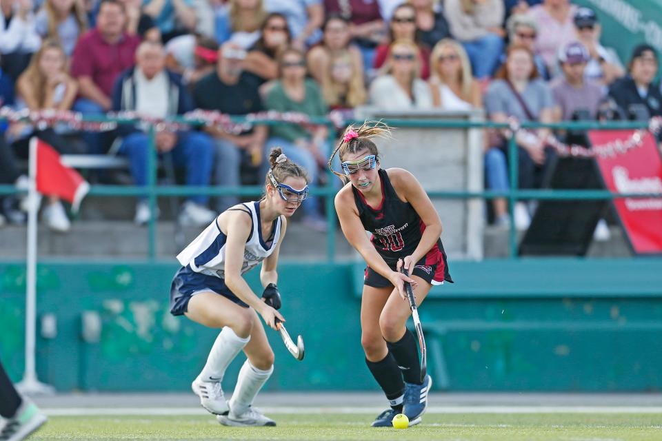 Alex  Mega of East Greenwich battles with Moses Brown's Ashley Brosseau at Cranston Stadium last fall.