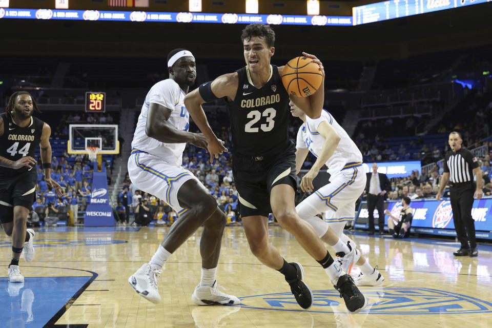 Colorado forward Tristan da Silva (23) dribbles past UCLA forward Adem Bona, center left, during the first half of an NCAA college basketball game Thursday, Feb. 15, 2024, in Los Angeles. (AP Photo/Raul Romero Jr.)