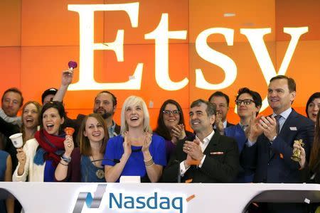 Etsy Inc's Chief Executive Officer Chad Dickerson (2nd from R) and Chief Financial Officer Kristina Salen (C) stand with Etsy Employees and Nasdaq Executive Vice President Bruce Aust (R) as they celebrate Etsy's initial public offering (IPO) at the Nasdaq market site in New York in an April 16, 2015 file photo. REUTERS/Mike Segar/Files