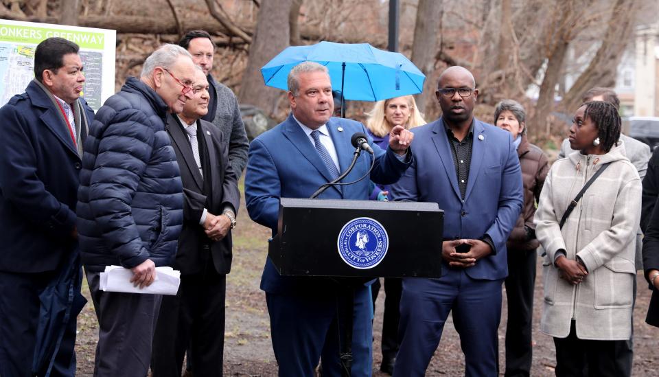Yonkers Mayor Mike Spano delivers remarks as U.S. Senate Majority Leader Charles E. Schumer, left and U.S. Rep. Jamaal Bowman look on at the Yonkers Greenway off of Lawrence Street Jan. 20, 2023, as Schumer revealed his major new push to help reconnect Southwest Yonkers with a first-of-its-kind greenway, increasing access to public transportation, revitalizing the South Broadway business district, and giving residents improved biking and walking access to NYC and Westchester.