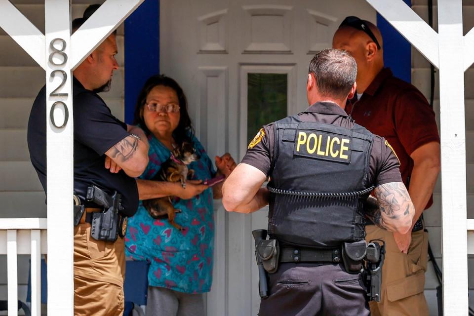 Henryetta Police Chief Steve Norman,left, visits the home of Nathan Brewer in Henryetta Okla., on Wednesday, May 3, 2023 (OKLAHOMAN)