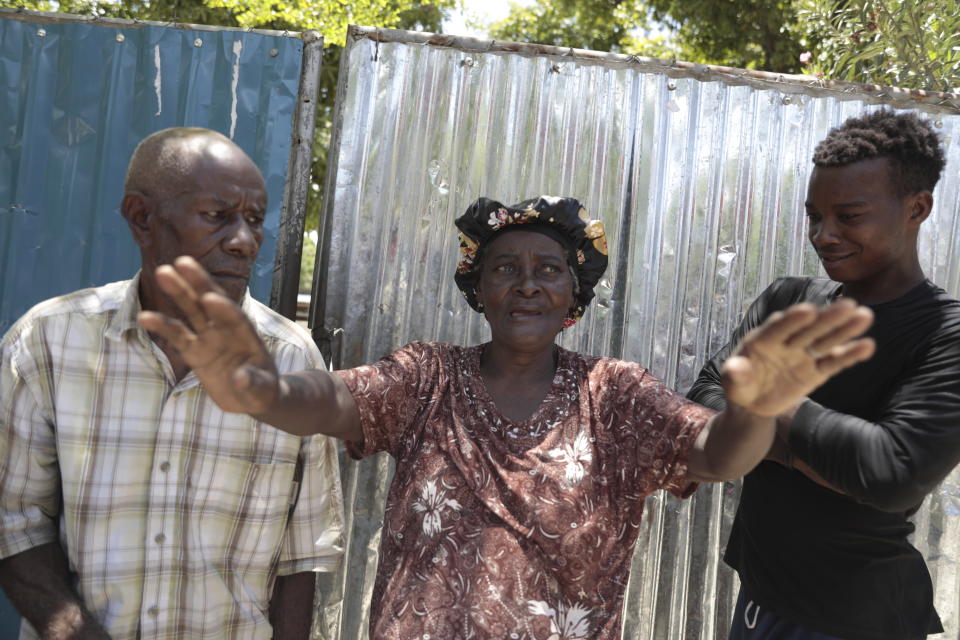 A woman expresses her happiness regarding the return of American nurse Alix Dorsainvil and her young daughter freed nearly two weeks after they were kidnapped, outside the El Roi Haiti school academy in the Cite Soleil community of Port-au-Prince, Haiti, Wednesday Aug. 9, 2023. (AP Photo/Odelyn Joseph)