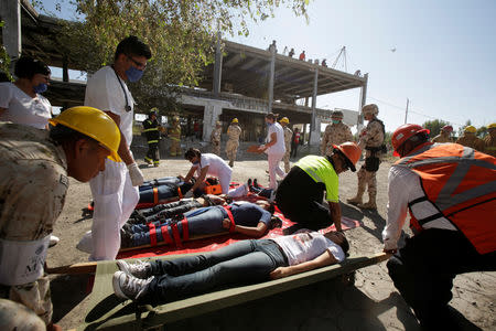 Rescue personnel take part in an earthquake drill during the first anniversary of the September 2017 earthquake, in Ciudad Juarez, Mexico September 19, 2018. REUTERS/Jose luis Gonzalez