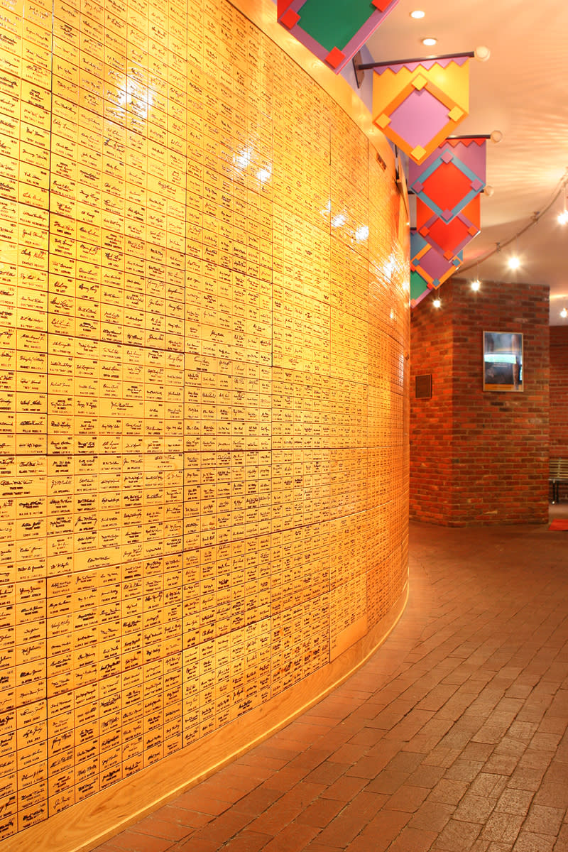 This undated image released by the Louisville Slugger Museum & Factory shows the signature wall at the museum in Louisville, Ky. Visitors can trace that baseball heritage along the Louisville Slugger Walk of Fame, stretching about a mile from the Louisville Slugger Museum & Factory to the city’s minor-league ballpark. (AP Photo/Hillerich & Bradsby)