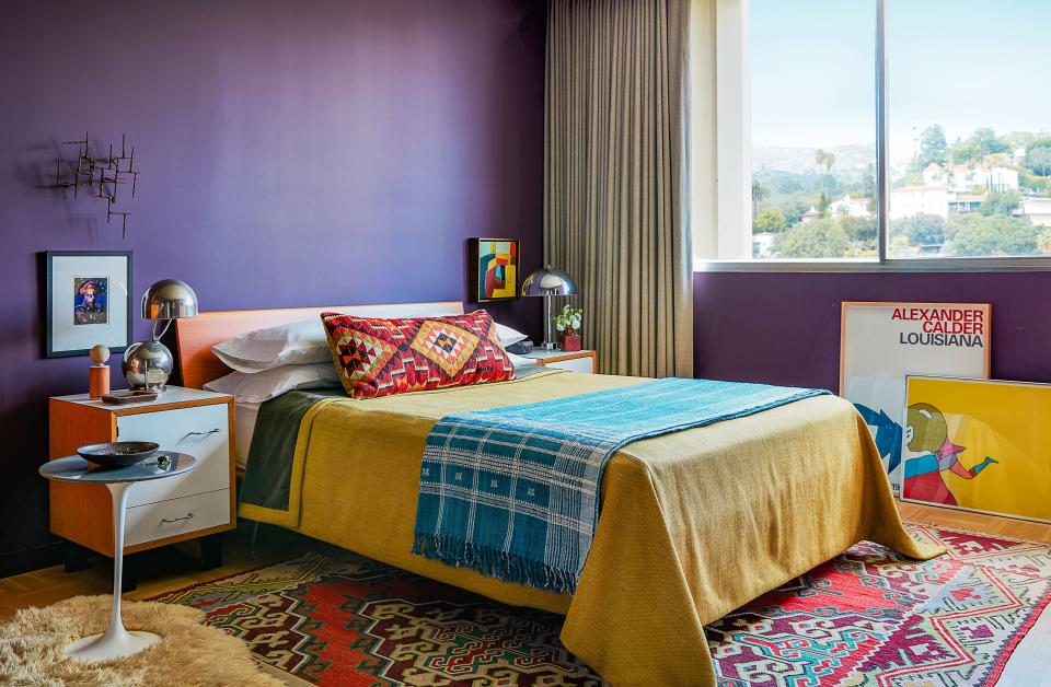 In Johanknecht’s master bedroom, George Nelson side tables edge a cherrywood bed. Bedcover of a Pierre Frey weave; Commune bolster pillow; Saarinen for Knoll side table; on walls, Farrow & Ball’s Pelt paint.