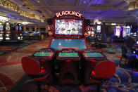 Chairs are removed to keep social distancing between players as a coronavirus safety precaution at an electronic gaming machine in the closed Bellagio hotel and casino, Wednesday, May 20, 2020, in Las Vegas. Casino operators in Las Vegas are awaiting word when they will be able to reopen after a shutdown during the coronavirus outbreak. (AP Photo/John Locher)