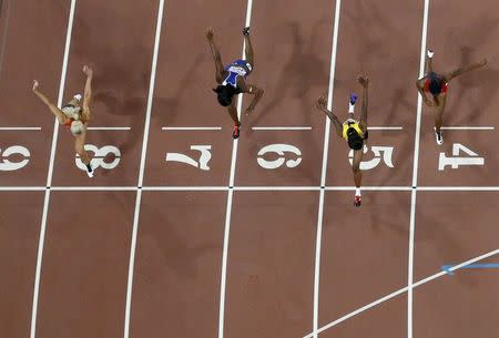 Danielle Williams (2nd R) of Jamaica crosses the finish line in front of Cindy Roleder of Germany (L) to win the women's 100 metres hurdles final during the 15th IAAF World Championships at the National Stadium in Beijing, China, August 28, 2015. REUTERS/Pawel Kopczynski