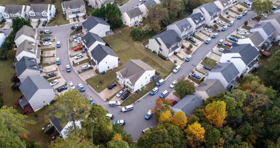 Raleigh Police line the streets while responding to an active shooter situation in the Hedingham neighborhood near the Neuse River Trail in Raleigh, Thursday, Oct. 13, 2022.