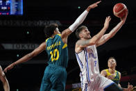 Italy's Achille Polonara (33) drives to the basket past Australia's Matisse Thybulle (10) during a men's basketball preliminary round game at the 2020 Summer Olympics, Wednesday, July 28, 2021, in Saitama, Japan. (AP Photo/Charlie Neibergall)