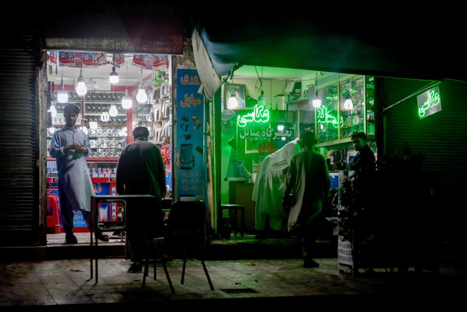 There are few street lights in Herat. The storefronts glow neon and fluorescent lights around the city.