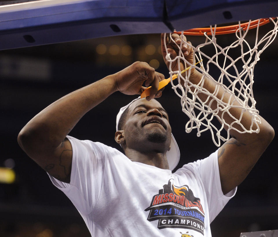 Wichita State's Chadrack Lufile cuts the net after Wichita's victory over Indiana State in an NCAA college basketball game in the championship of the Missouri Valley Conference men's tournament, Sunday, March 9, 2014, in St. Louis. (AP Photo/Bill Boyce)
