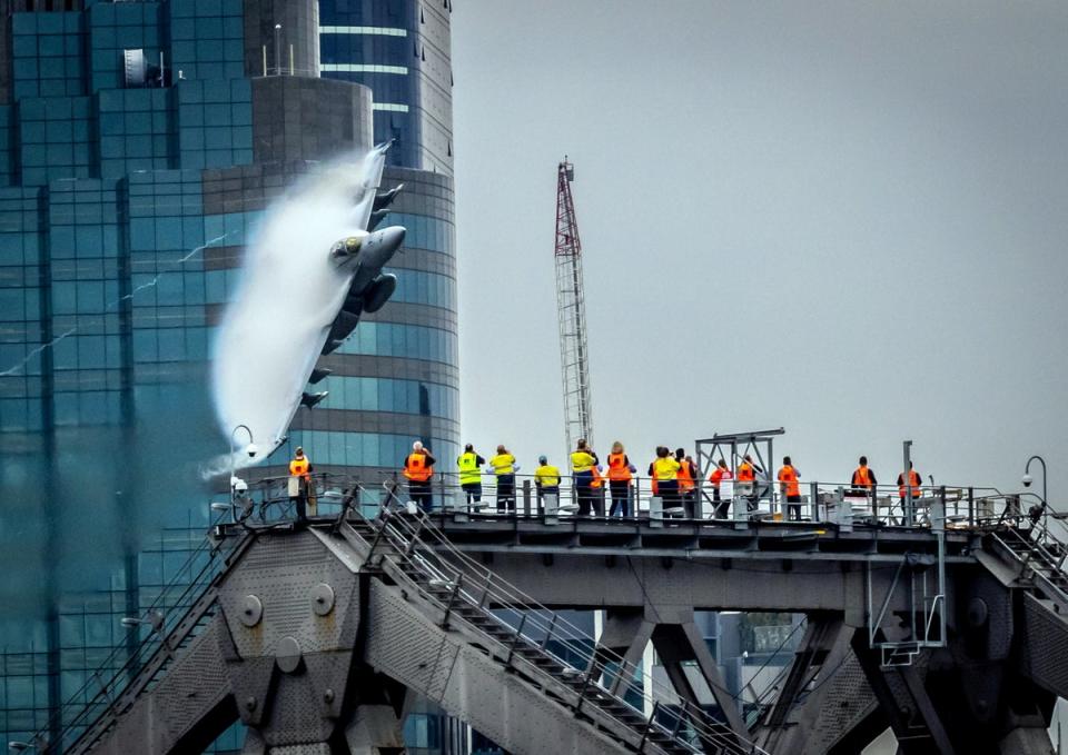 A fighter jet zooming at low level through a city (David A Kapernick/SWNS)