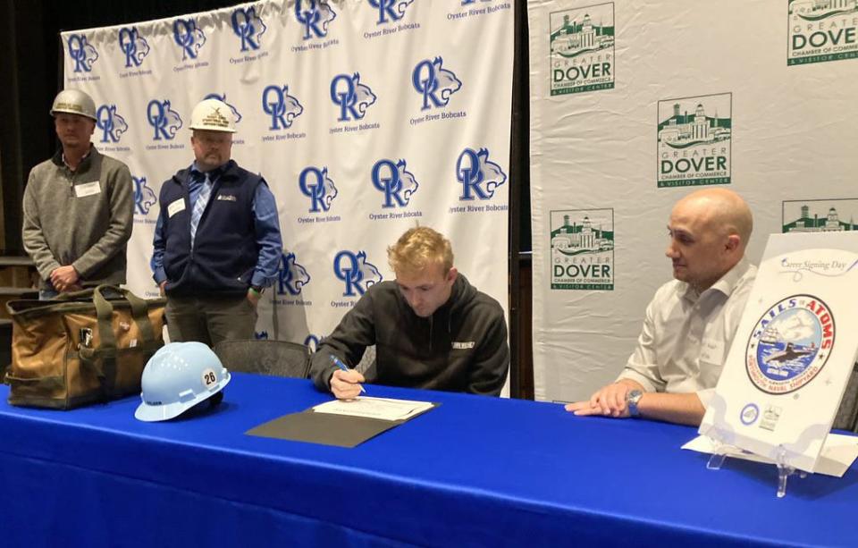 Oyster River High School Class of 2023 graduating senior James Barrett signs his certificate of intent June 5 to become an apprentice welder at the Portsmouth Naval Shipyard.