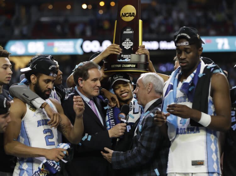North Carolina head coach Roy Williams us interviewed as he celebrates with his team.